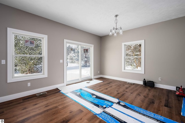 interior space featuring hardwood / wood-style floors, a textured ceiling, and a chandelier