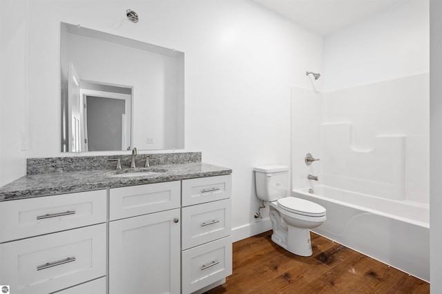 full bathroom featuring vanity, hardwood / wood-style floors, tub / shower combination, and toilet