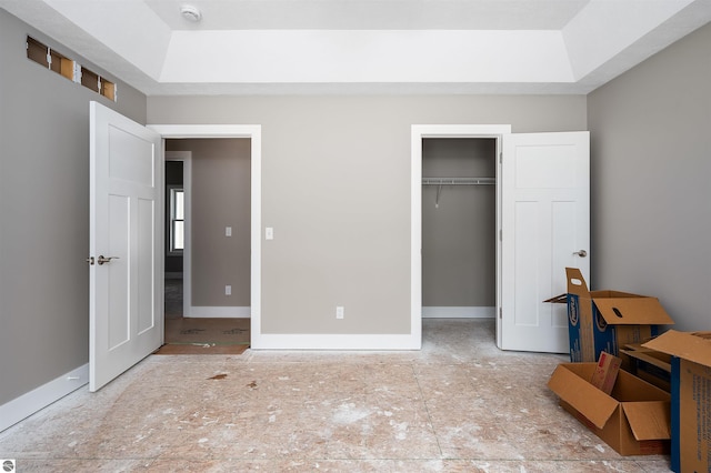 bedroom featuring a raised ceiling and a closet