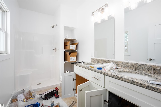 bathroom with vanity and a shower