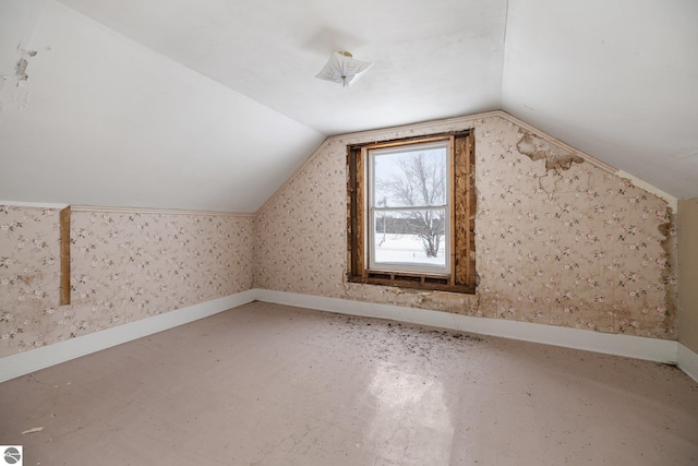 additional living space featuring lofted ceiling