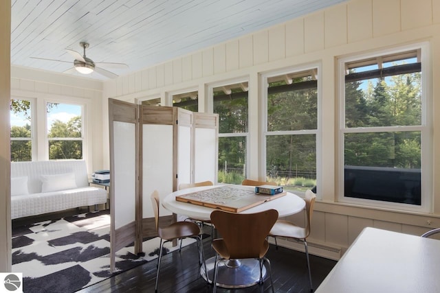 sunroom featuring ceiling fan, a baseboard heating unit, and wooden ceiling