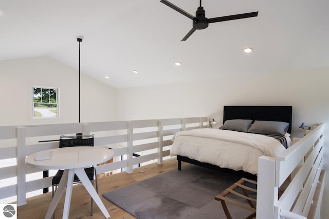 bedroom featuring ceiling fan, hardwood / wood-style floors, and vaulted ceiling