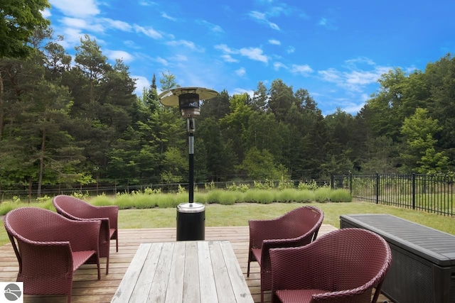 wooden deck featuring a lawn