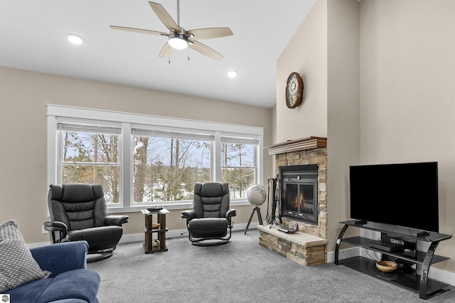 living room with ceiling fan, carpet, and a fireplace