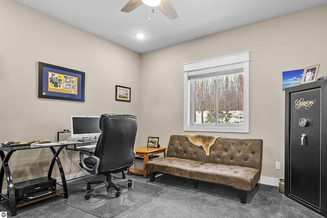 home office with dark colored carpet and ceiling fan