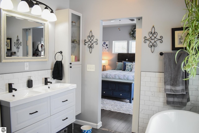 bathroom featuring hardwood / wood-style flooring, a bathtub, and vanity