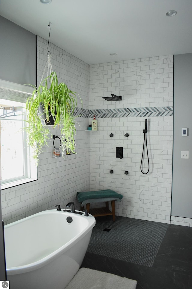 bathroom featuring shower with separate bathtub