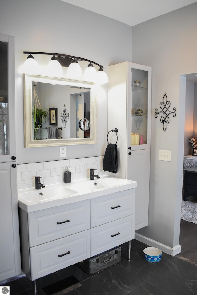 bathroom with decorative backsplash and vanity