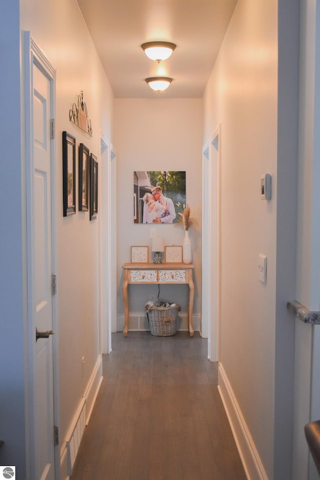 hallway with dark hardwood / wood-style flooring