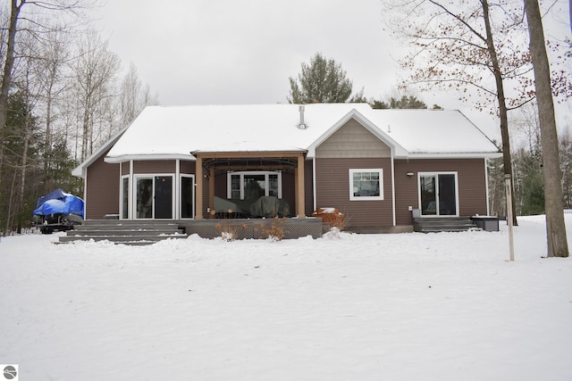 snow covered property featuring covered porch