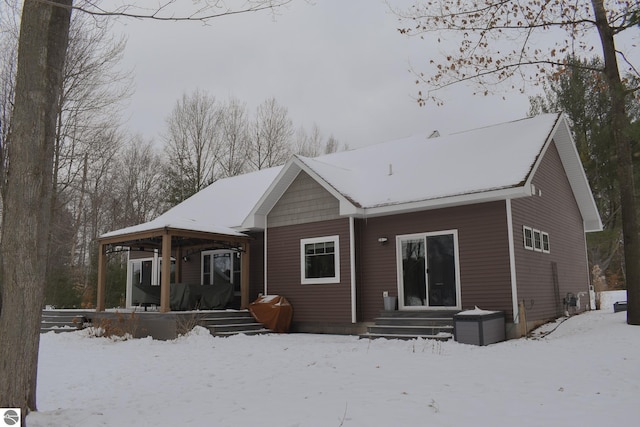 snow covered house with covered porch