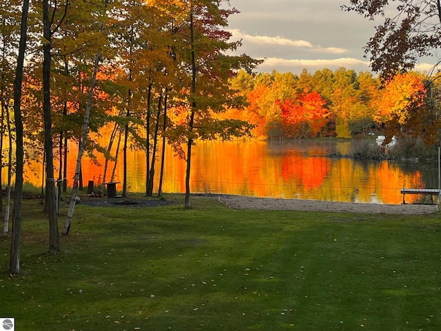 surrounding community featuring a water view and a yard