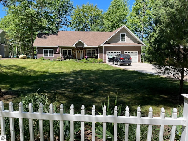 view of front of home featuring a front yard and a garage