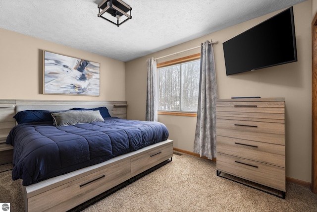 bedroom with light colored carpet and a textured ceiling