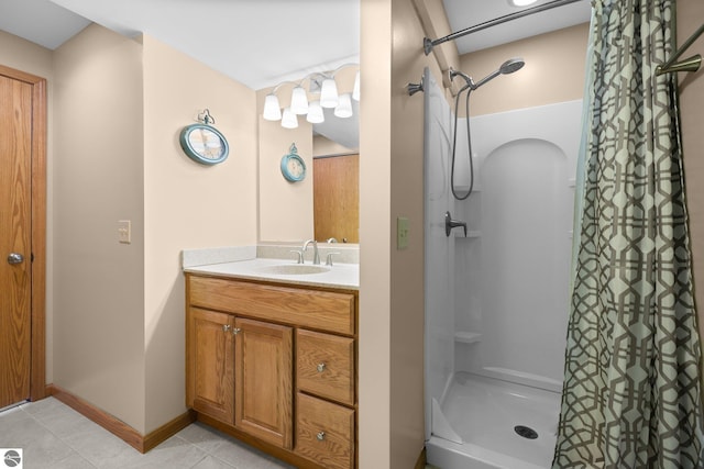 bathroom featuring vanity, tile patterned flooring, and curtained shower