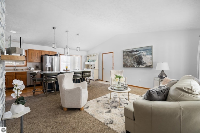 living room featuring vaulted ceiling, sink, dark carpet, and a textured ceiling