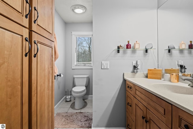 bathroom with tile patterned floors, vanity, and toilet