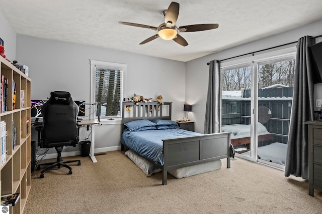 bedroom with a textured ceiling, multiple windows, carpet floors, and ceiling fan