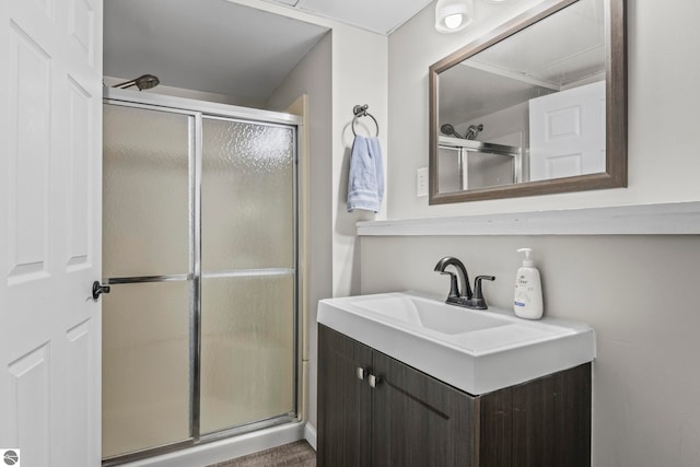 bathroom featuring vanity and a shower with door