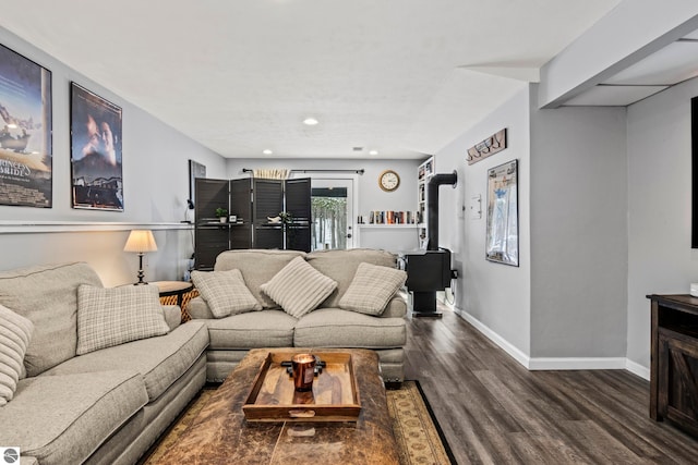 living room featuring a wood stove and dark hardwood / wood-style flooring