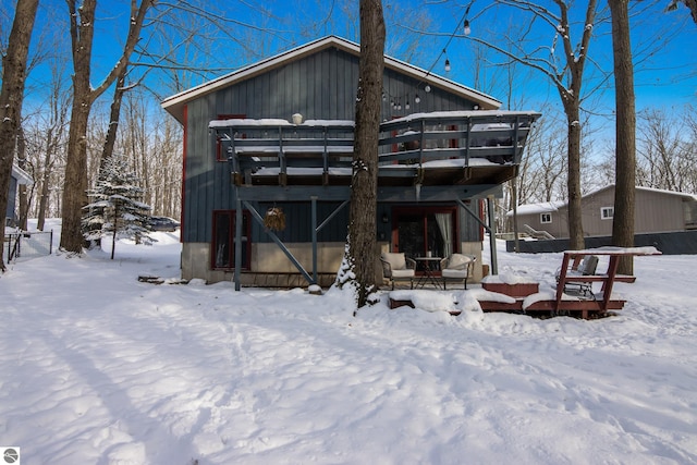 view of snow covered rear of property