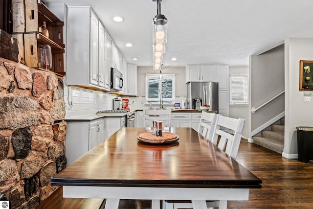 dining room featuring sink and dark hardwood / wood-style floors