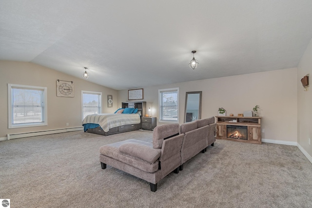 carpeted bedroom with a baseboard heating unit and vaulted ceiling