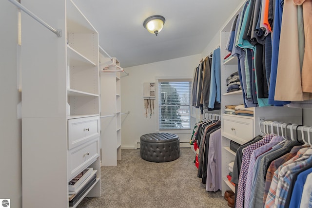 walk in closet featuring baseboard heating, lofted ceiling, and light colored carpet