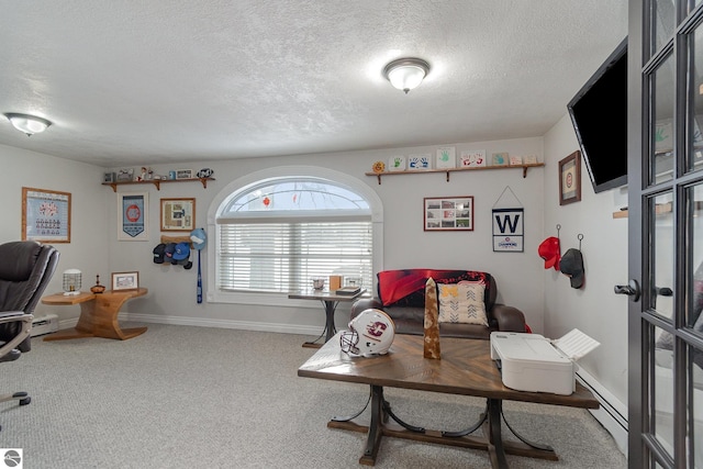 carpeted home office with a textured ceiling and a baseboard heating unit