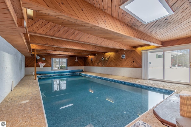 view of swimming pool featuring a skylight