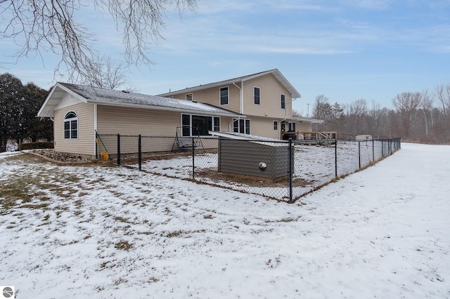 view of snow covered back of property