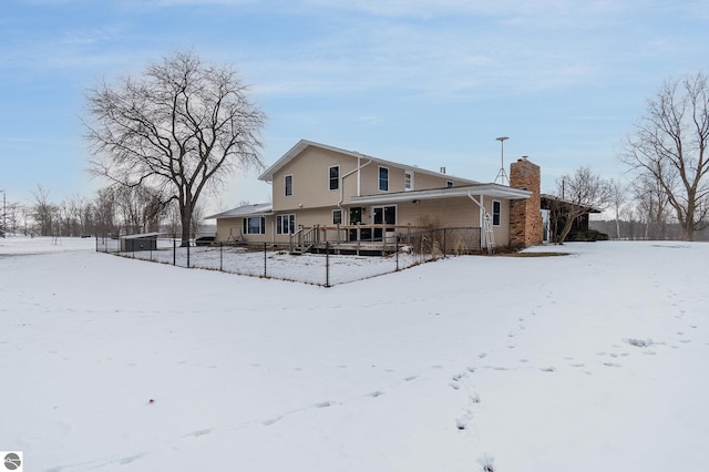 snow covered property with a deck