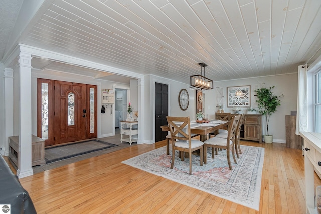 dining space with wooden ceiling, ornate columns, light hardwood / wood-style flooring, and a notable chandelier