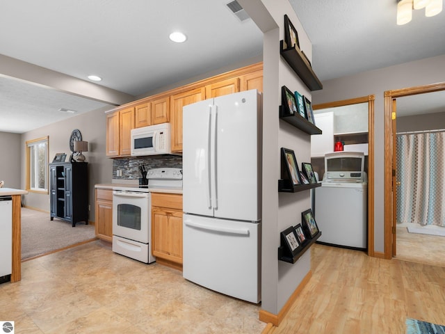 kitchen featuring white appliances, washer / clothes dryer, light brown cabinets, decorative backsplash, and light wood-type flooring