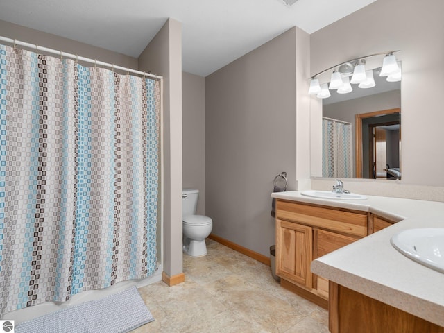 bathroom with toilet, a shower with shower curtain, and vanity