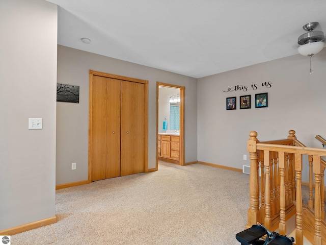 carpeted bedroom with a closet and ensuite bath