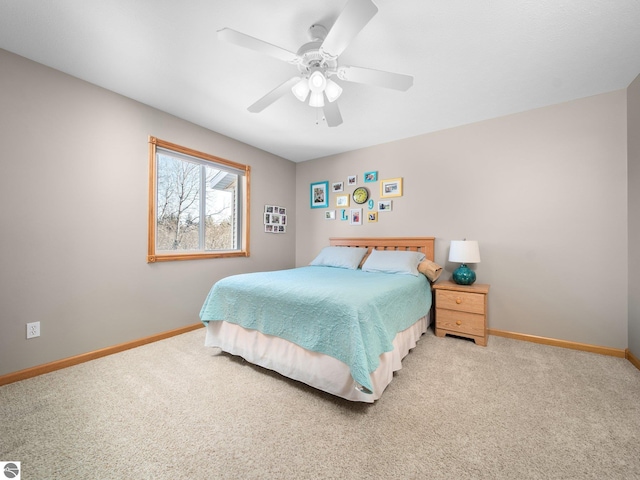 bedroom with ceiling fan and light carpet