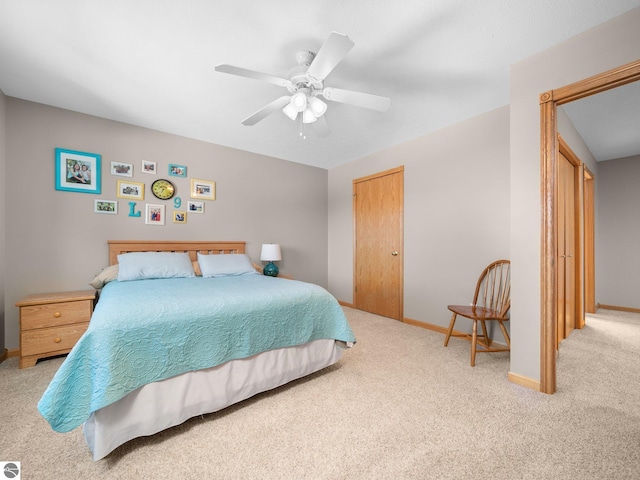 bedroom featuring a closet, ceiling fan, and light carpet