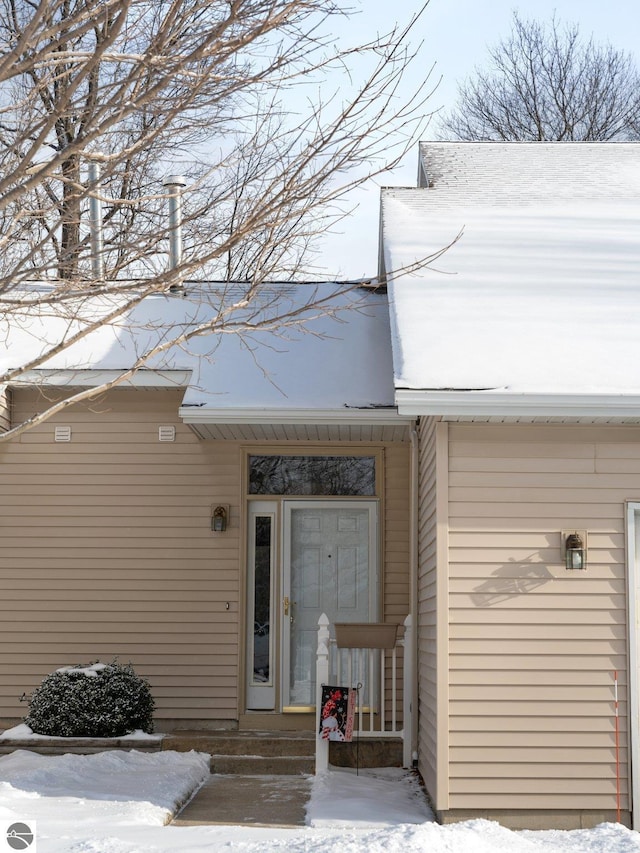 view of snow covered property entrance