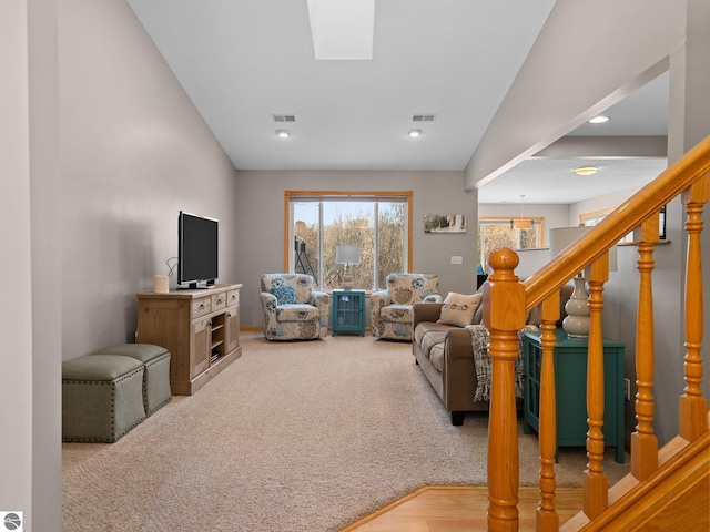 carpeted living room featuring vaulted ceiling