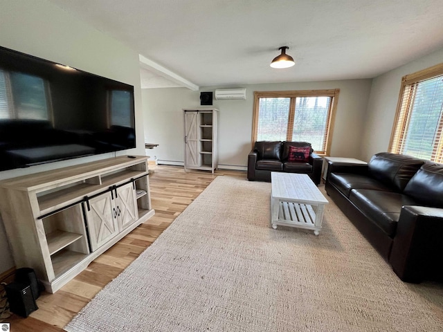 living room featuring a baseboard radiator, a healthy amount of sunlight, a wall mounted air conditioner, and light hardwood / wood-style flooring