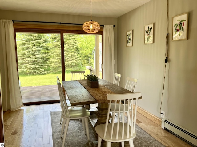 dining area featuring light wood-type flooring and a baseboard radiator