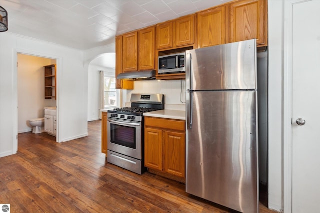 kitchen featuring appliances with stainless steel finishes and dark hardwood / wood-style flooring