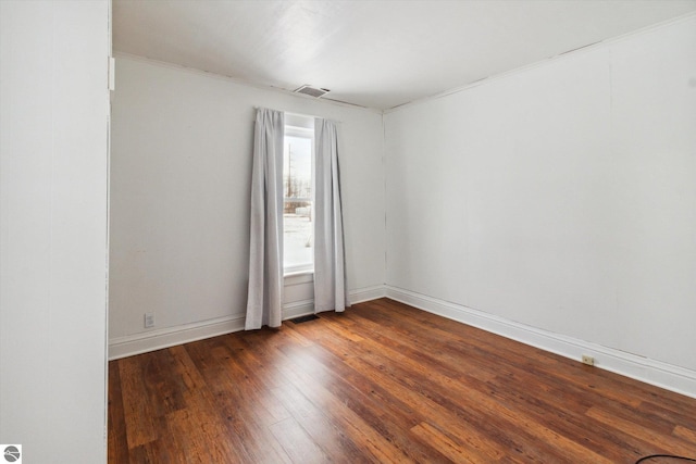 spare room with dark hardwood / wood-style floors