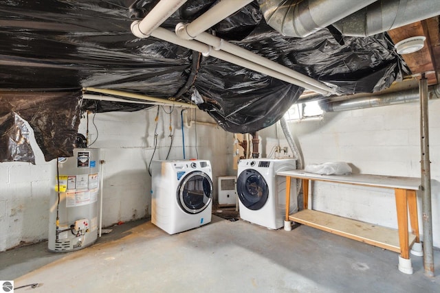 basement with washer and clothes dryer and water heater