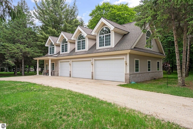 cape cod-style house with a garage and a front lawn