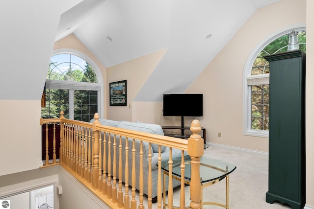 interior space with light colored carpet and vaulted ceiling