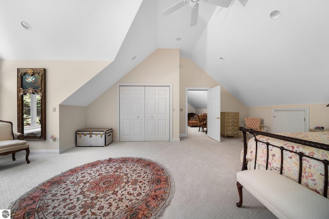 carpeted bedroom featuring lofted ceiling, a closet, and ceiling fan