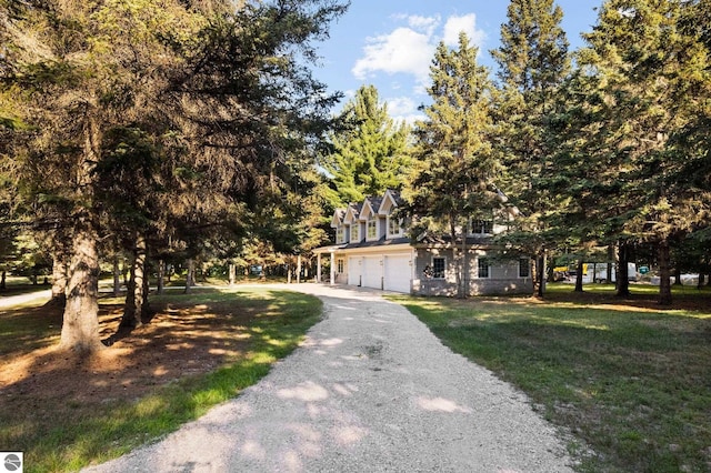 obstructed view of property featuring a front yard and a garage